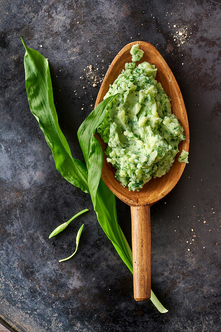 Wild garlic (ramp) mash on a wooden spoon