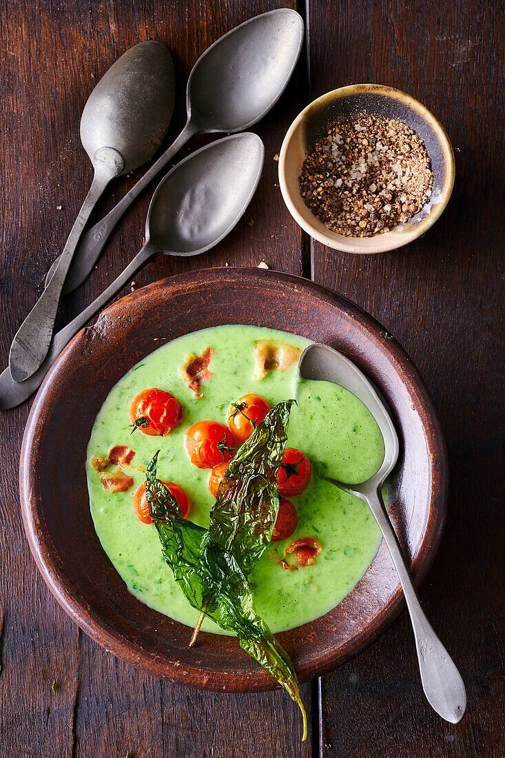 Wild garlic soup (ramp) with cherry tomatoes and smoked bacon