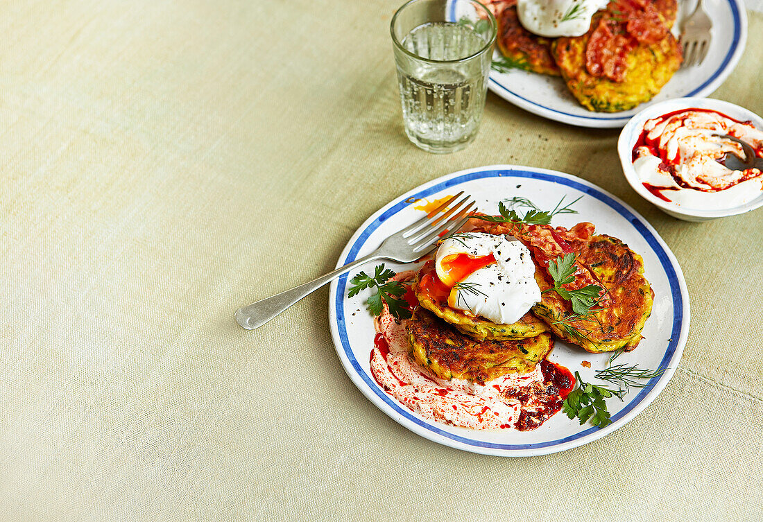 Courgette and ricotta fritters with poached eggs and harissa yogurt