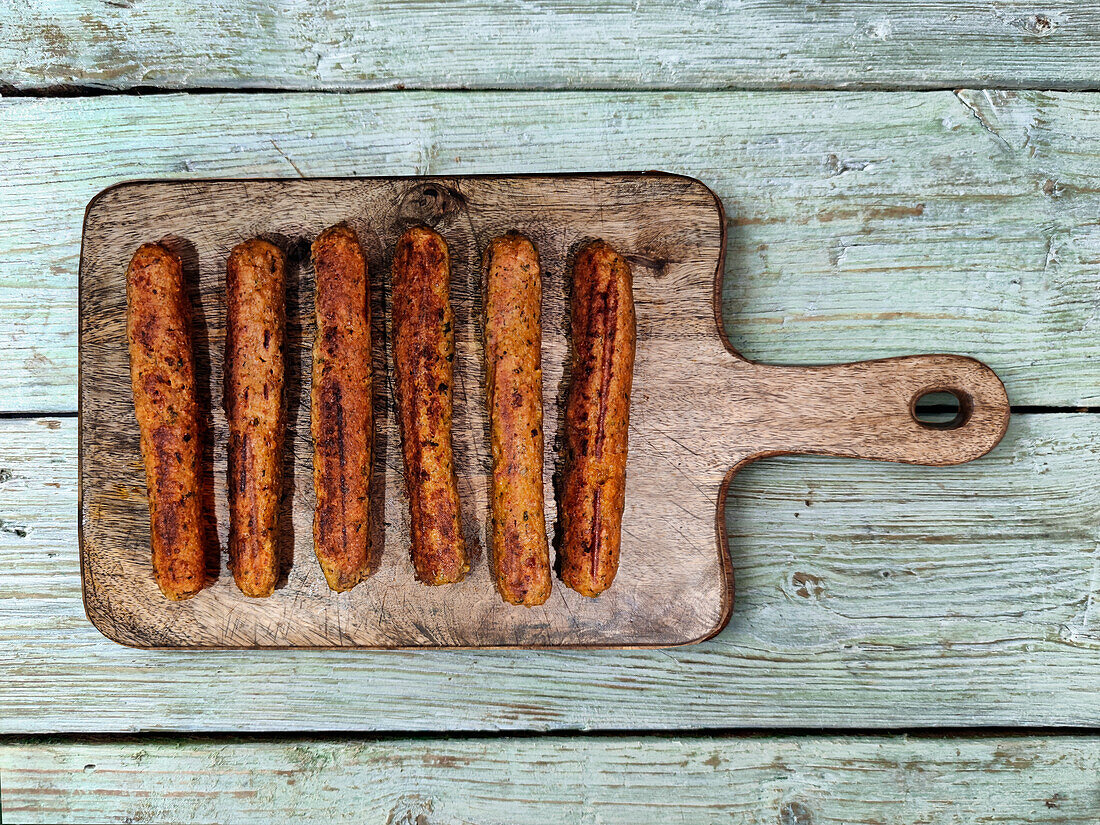 Vegane Bratwürste auf Holzbrett