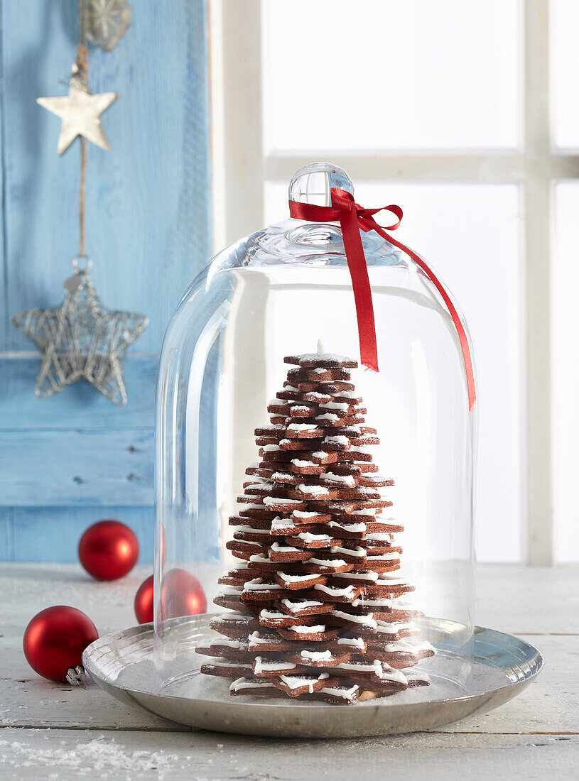 Weihnachtsbaum aus Schokoladenplätzchen unter Glashaube