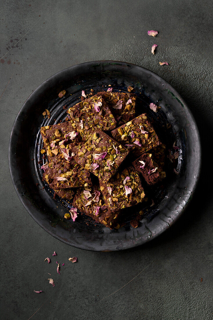 Pistachio brownies garnished with dried rose petals