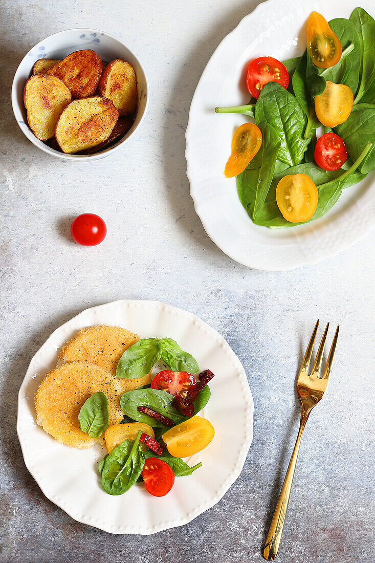 Breaded scamorza with spinach and cherry tomatoes