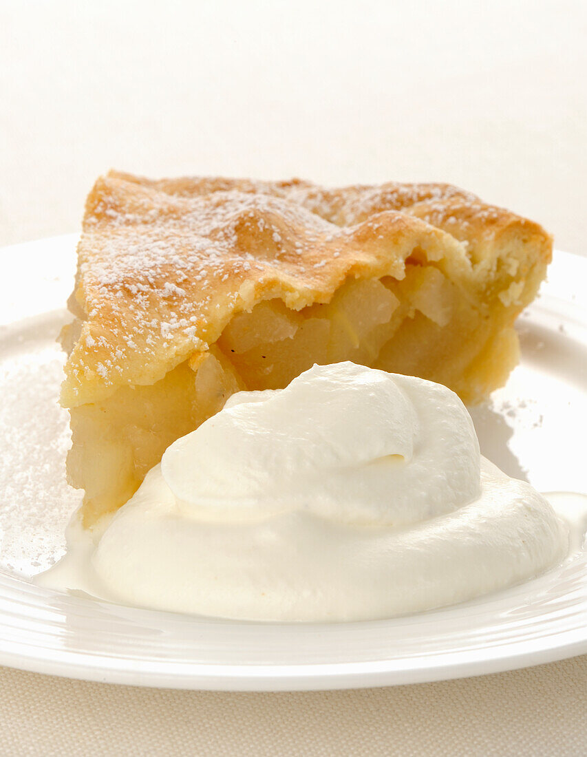 A slice of pear pie with cream