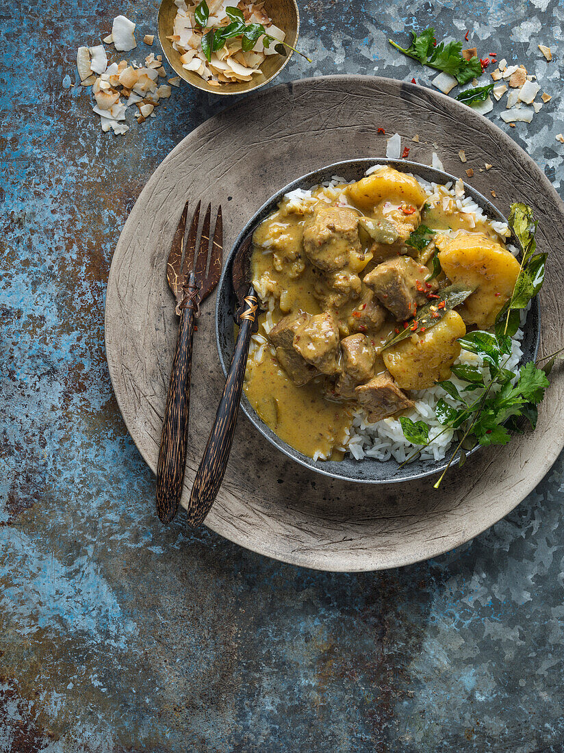 Pork Massaman Curry served with rice in a bowl