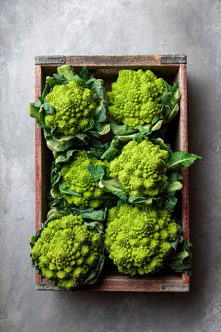 Multiple heads of romanesco in a wooden crate