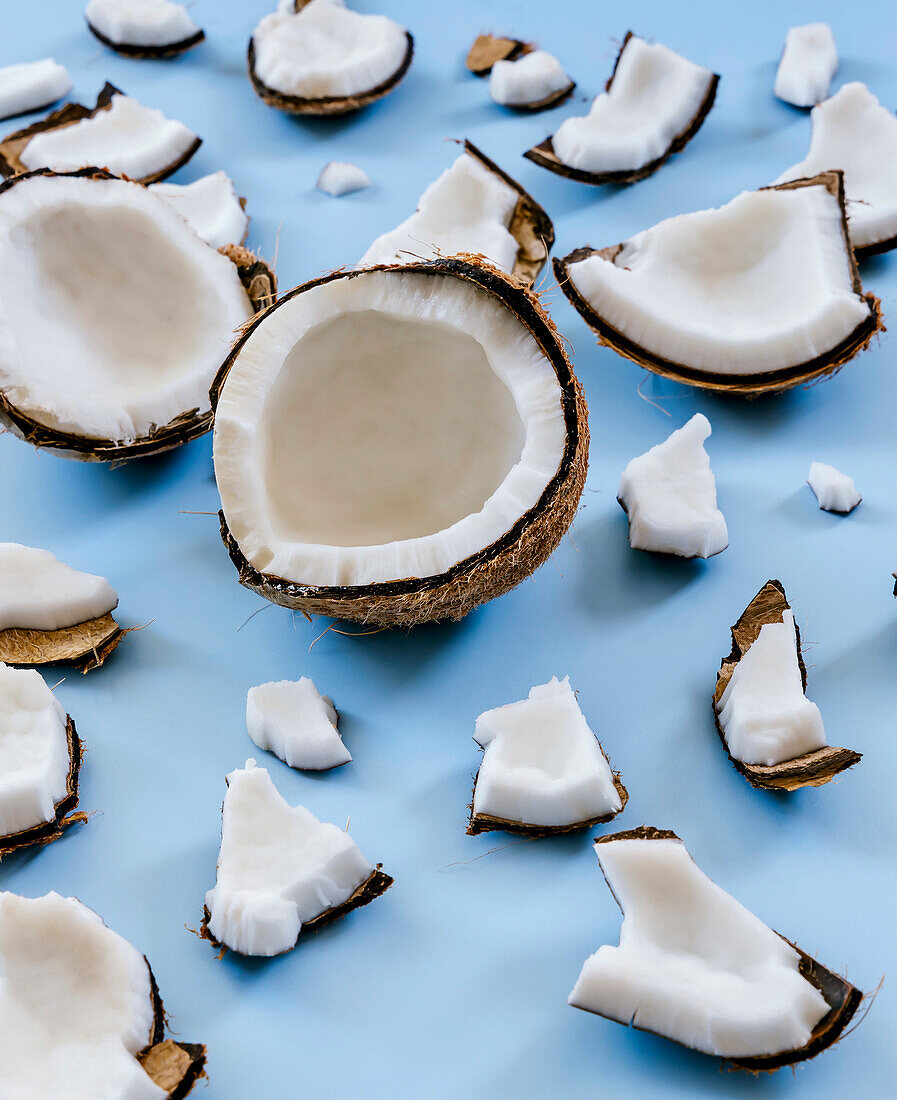 Broken coconut shells on a blue background
