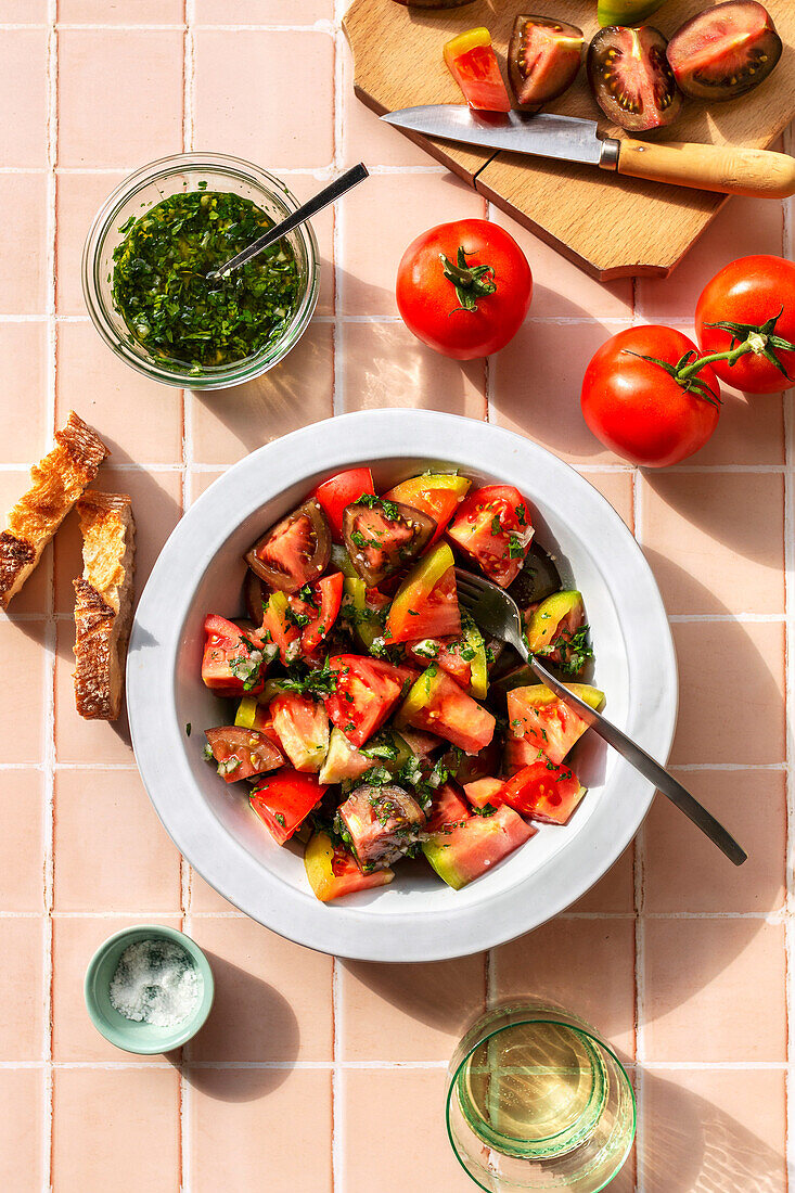Tomato salad with salsa vinaigrette on the table