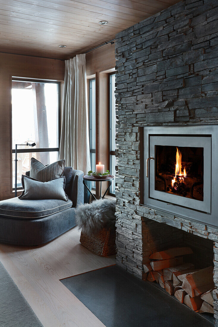 Fireplace in stone chimney breast in elegant living room