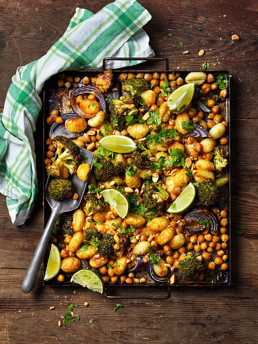 Baked gnocchi with chickpeas, broccoli, parsley, lime, red onion and peanuts