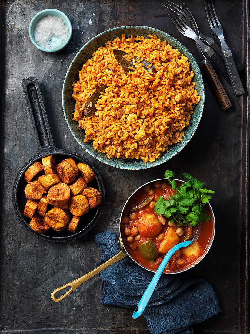 Fried bananas, fried spicey rice and stew with tomatoes, potatoes, chickpeas and coriander