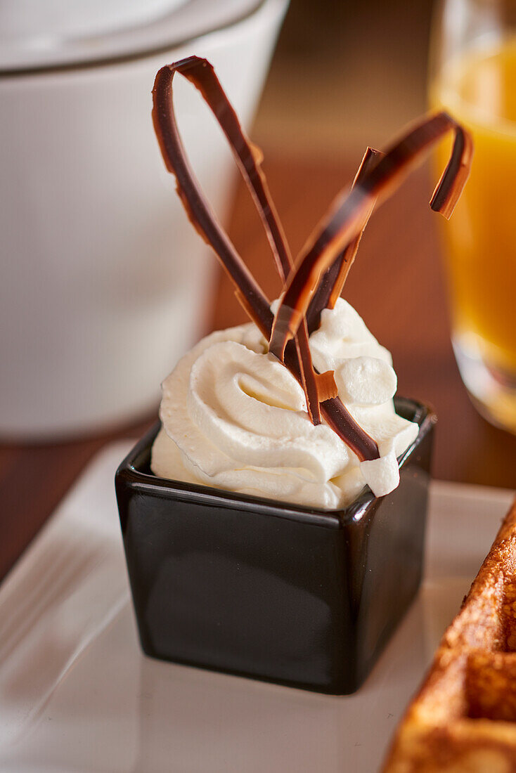 Whipped cream with a decorative chocolate garnish