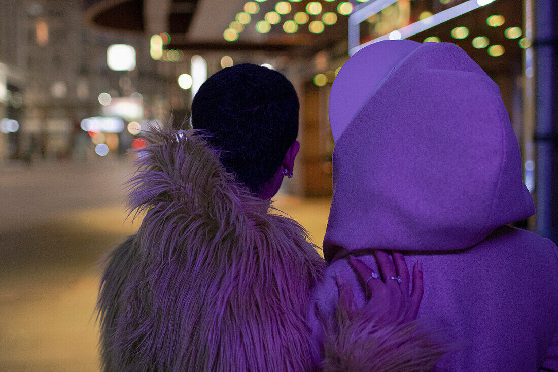 Couple on dark city sidewalk