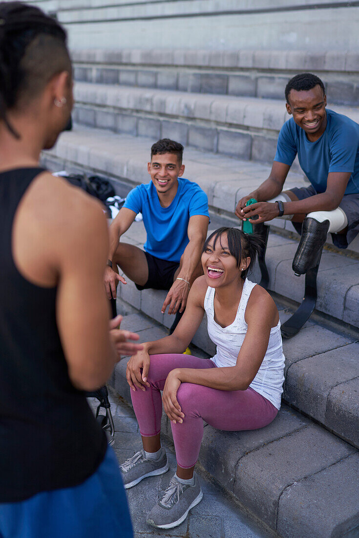 Happy athletes talking on steps