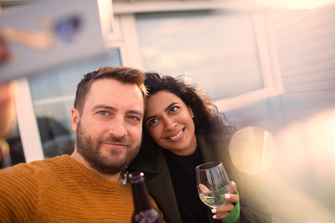 Happy couple taking selfie on patio