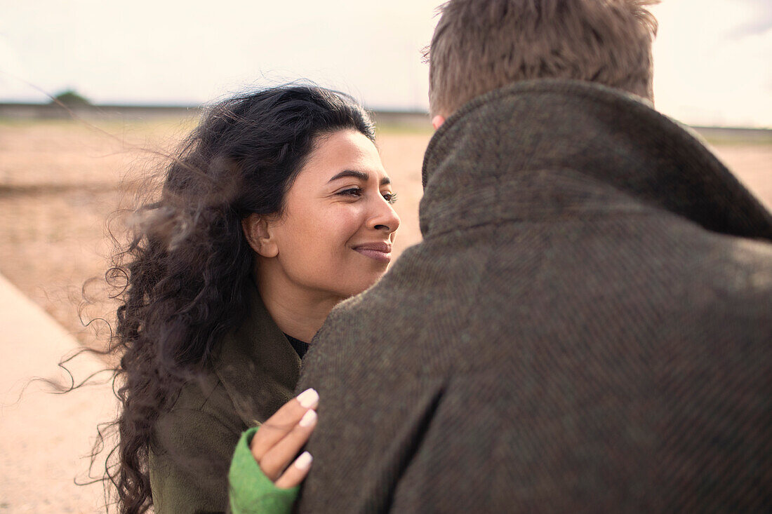 Happy woman hugging boyfriend on beach