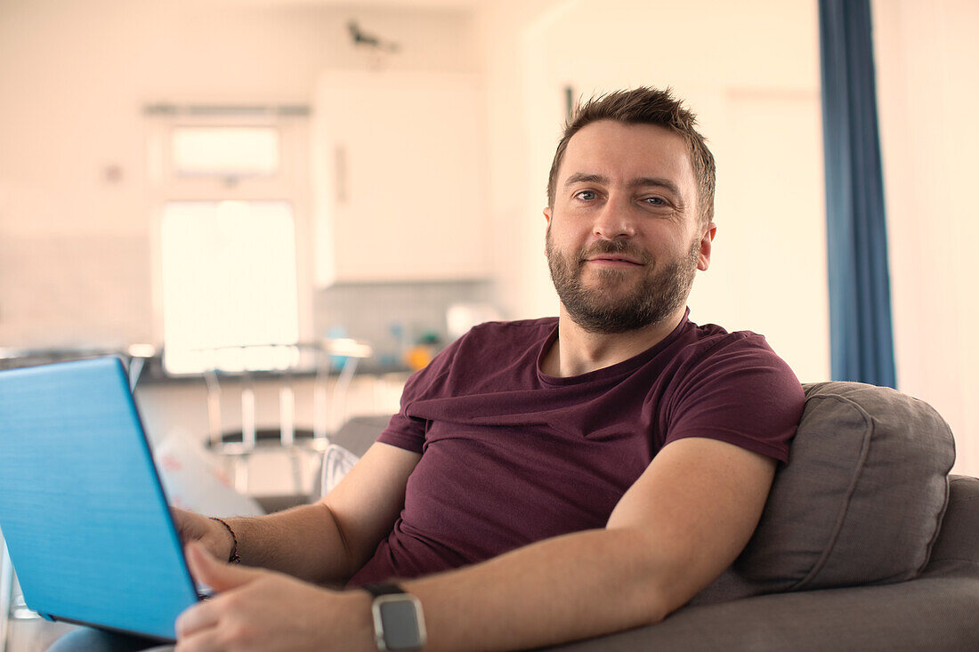 Confident man working from home on laptop