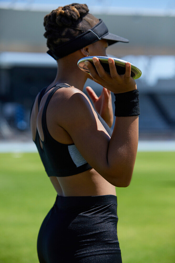 Female track and field athlete preparing to throw discus