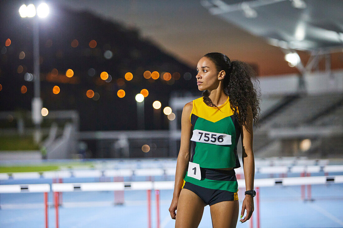 Determined athlete on track at night