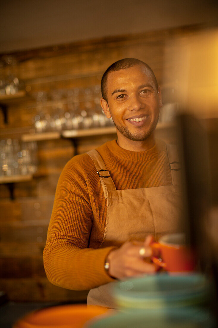 Smiling confident barista preparing coffee in cafe