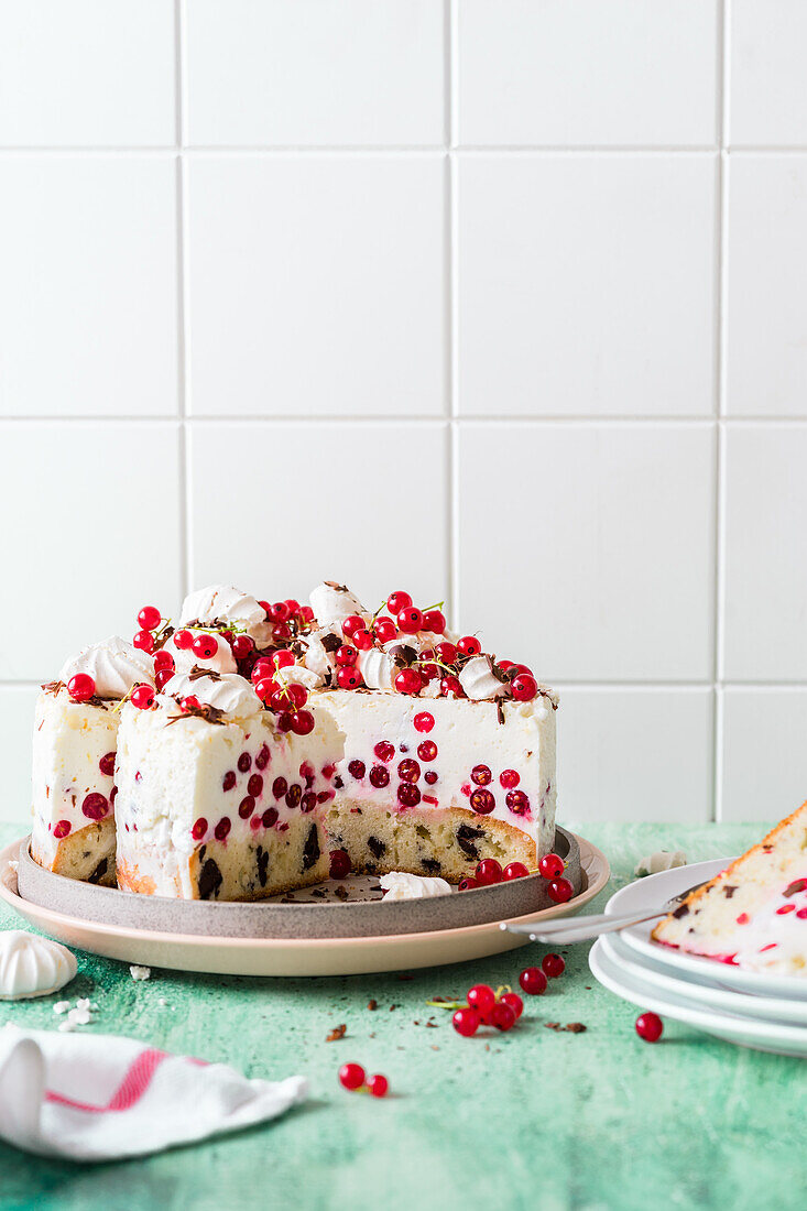Currant yogurt mousse cake with chocolate chips and meringue dots