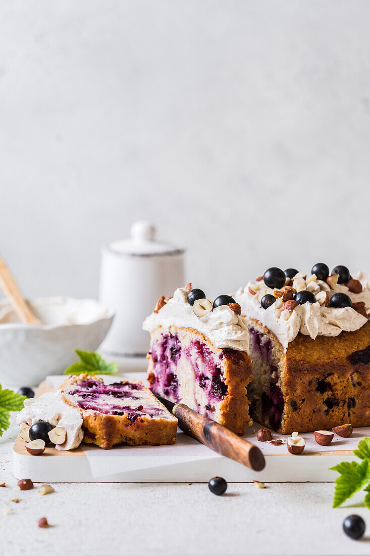 Black currant yogurt cake with a whipped cinnamon cream cheese topping