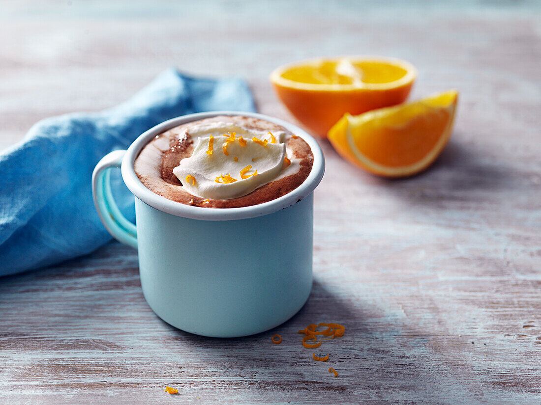 Hot cocolate with whiooed cream and orange
