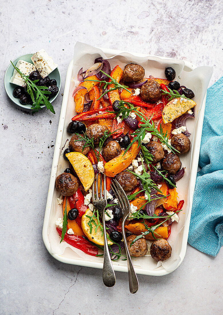 Meatballs on a tray with oven vegetables and pumpkin