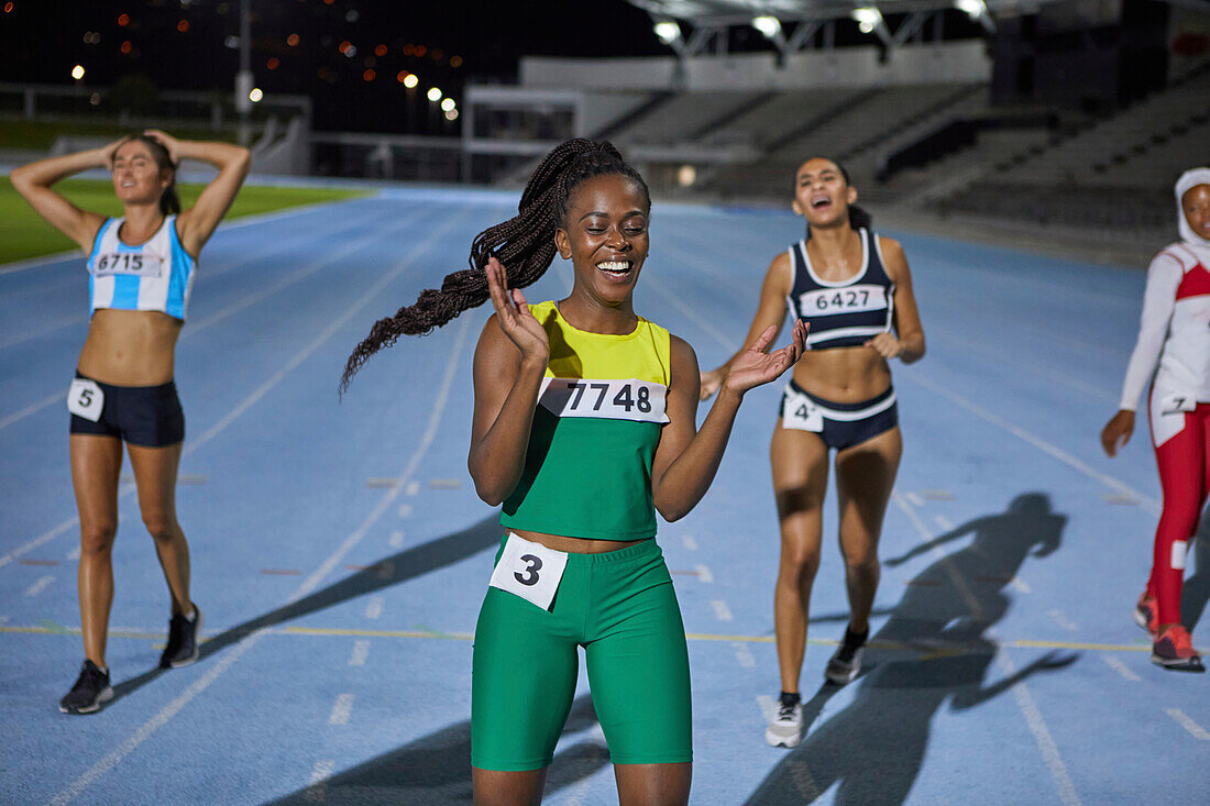 Happy athlete celebrating after race on track