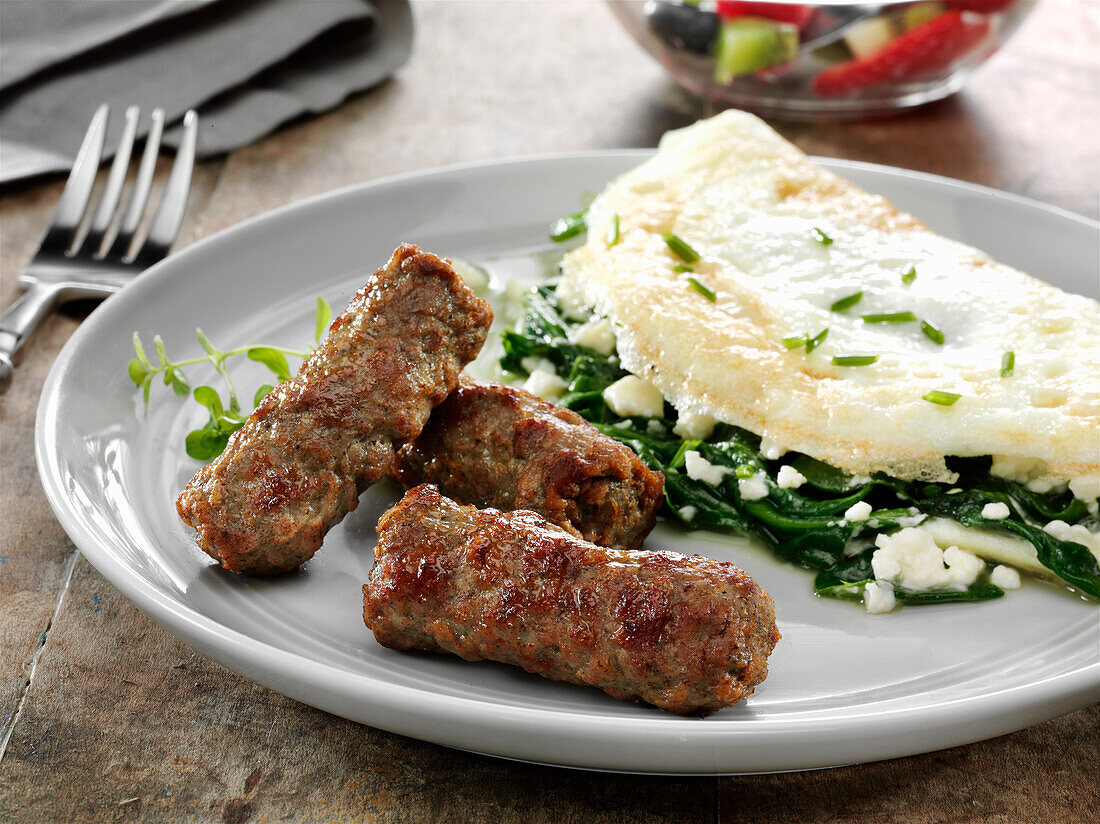 Skinless turkey breakfast sausage with an egg white spinach and feta cheese omelette