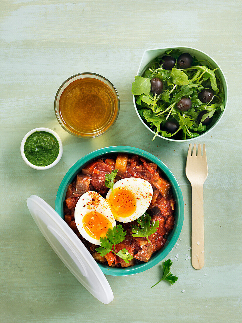 Ratatouille with boiled eggs, salas with olives and ruccola, parsleydip