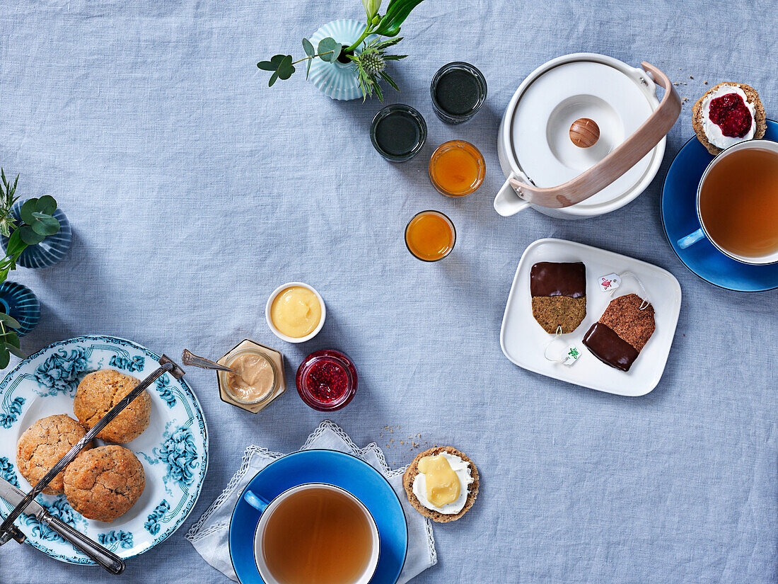 Scones with lemoncurd, jam and clotted cream, tea, teacookies, shots with tumeric and greens