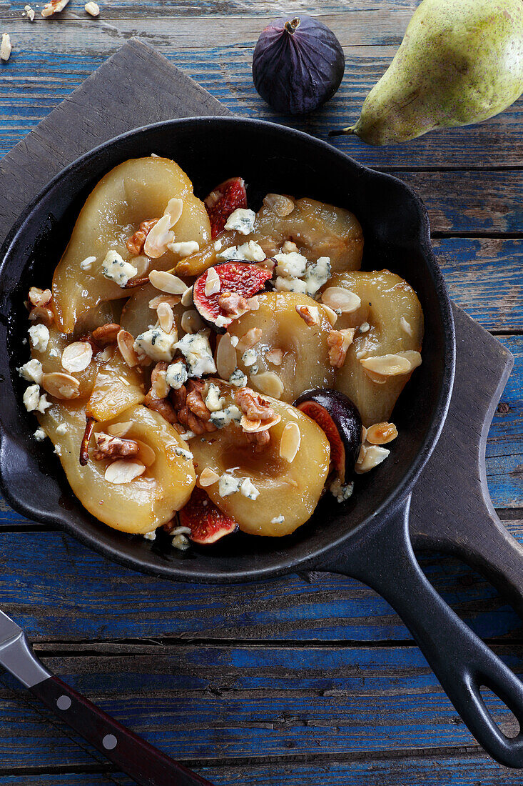 Pears stewed in white wine with figs, almonds, nuts and blue cheese