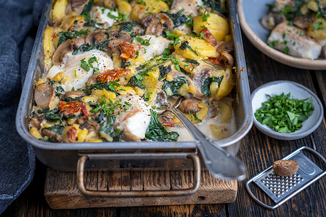 Potato and fish bake with mushrooms and spinach