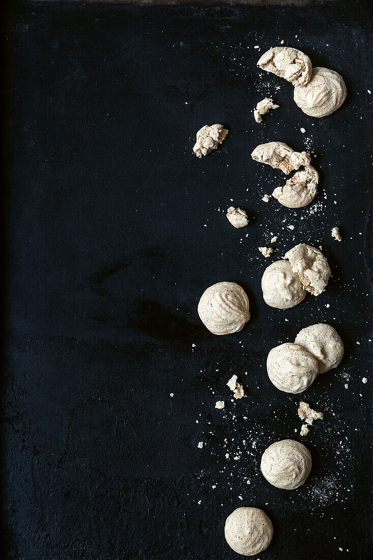Walnut macaroons on a black surface