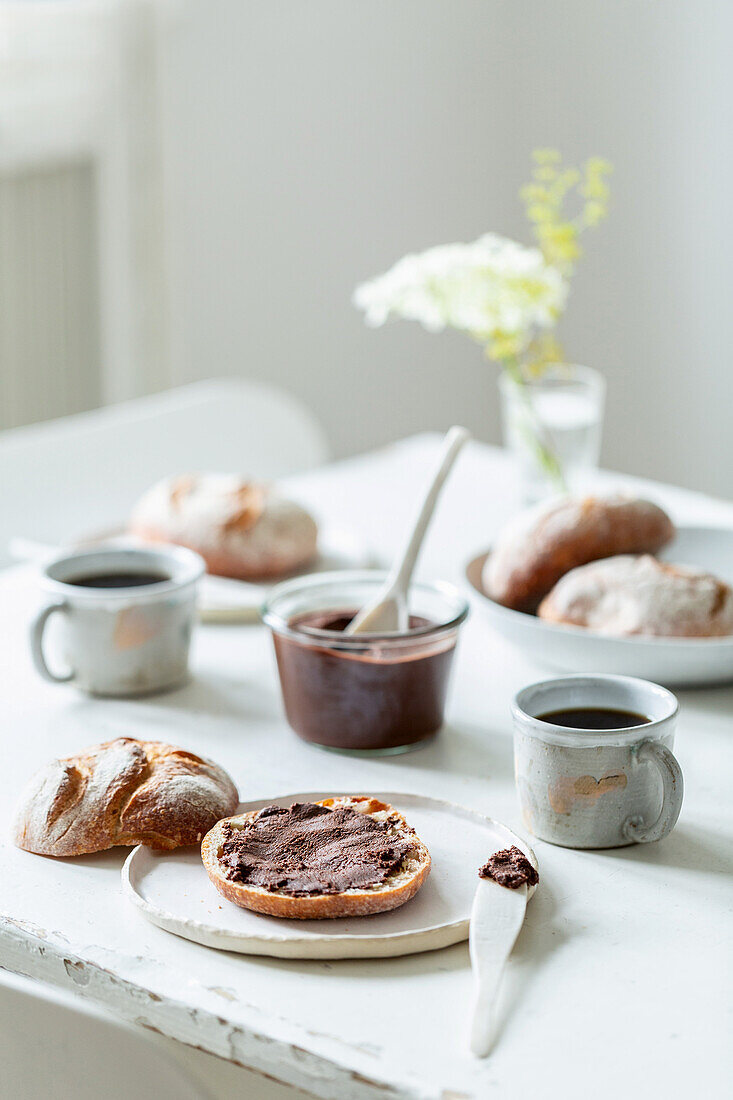 Rolls with homemade nut-nougat cream on a kitchen table