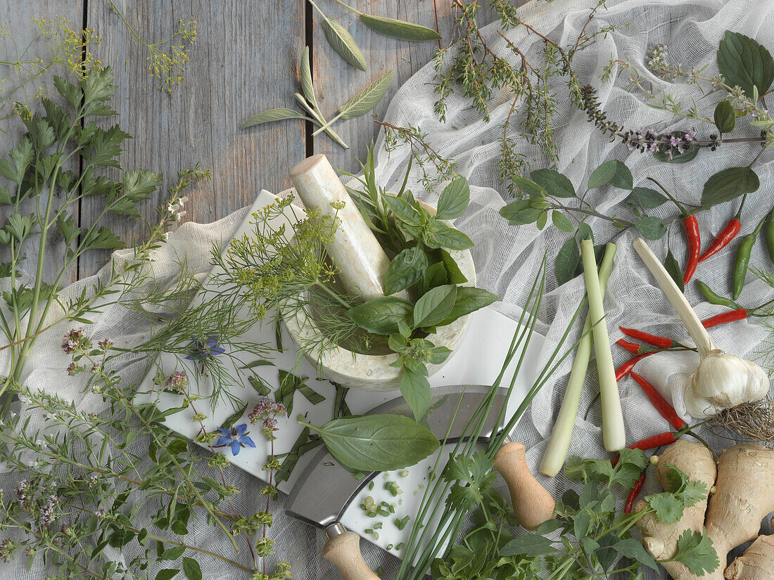 Fresh herbs, mortar and a chopping knife