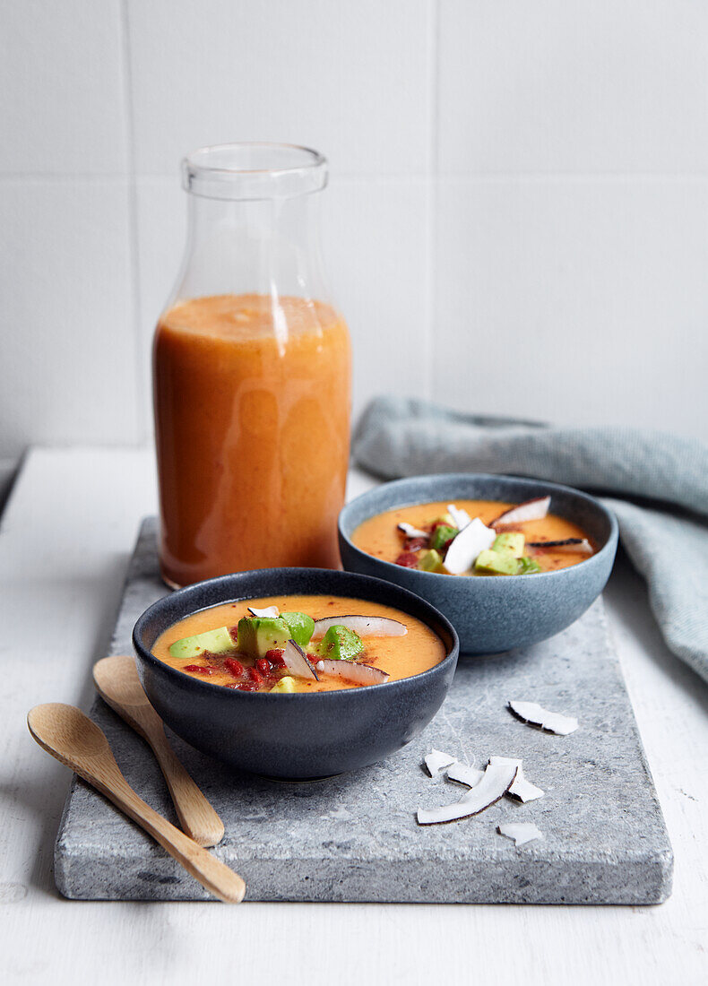 Vegan tomato soup with avocado and coconut flakes