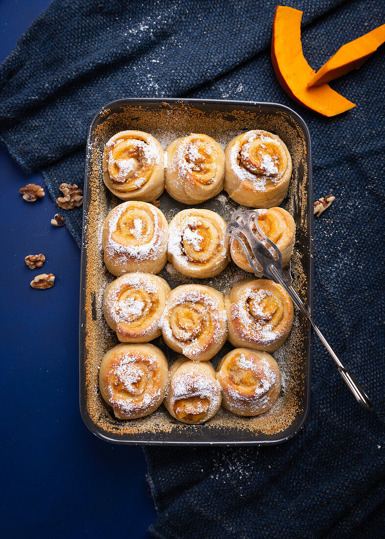 Vegan yeast dough buns filled with pumpkin pudding and walnuts