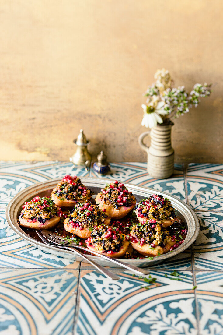 Stuffed quinces with chickpeas, red cabbage, nuts and pomegranate seeds