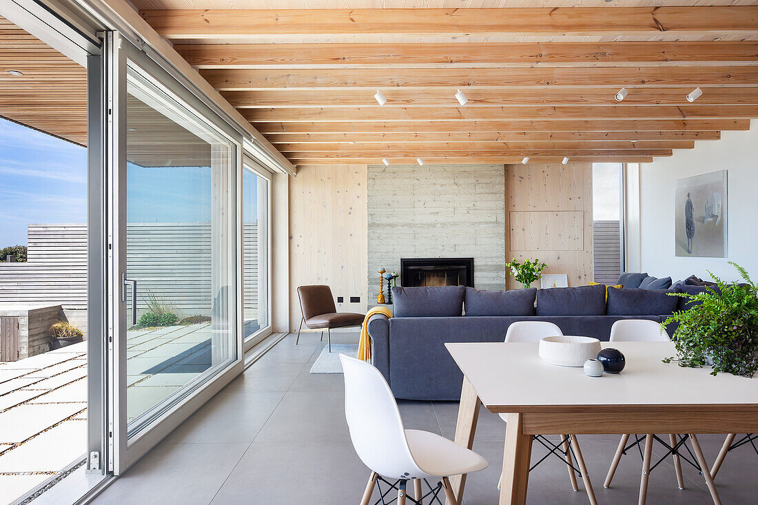 Open-plan living room with dining table and sofa in modern architect-designed house