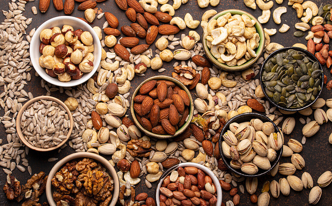 Assorted nuts and various seeds in bowls
