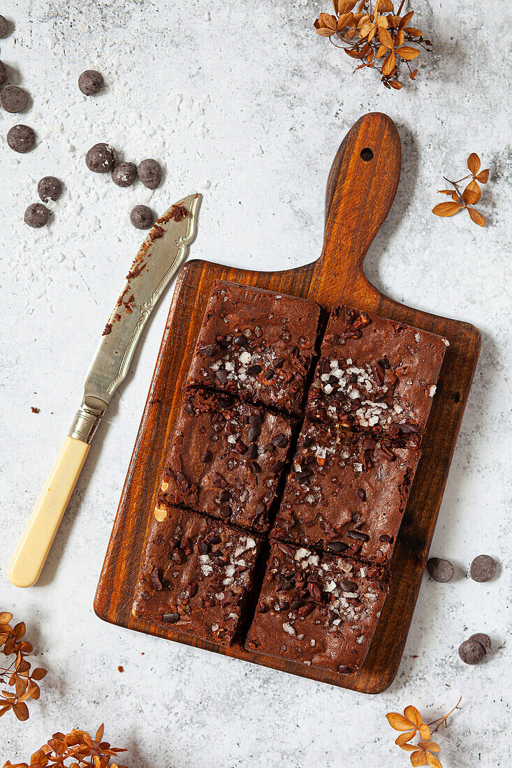 A paper baking tray of chocolate brownies cut into squares