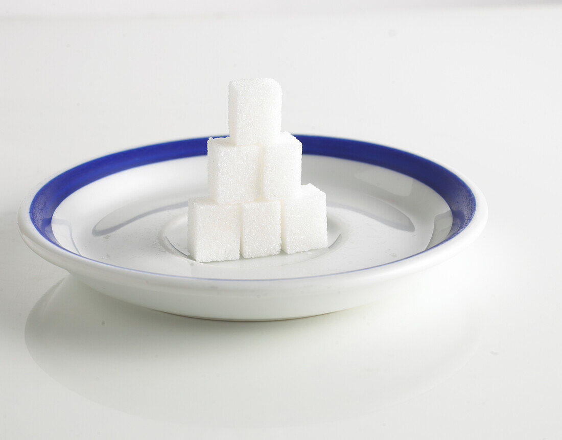 Stack of sugar cubes on plate