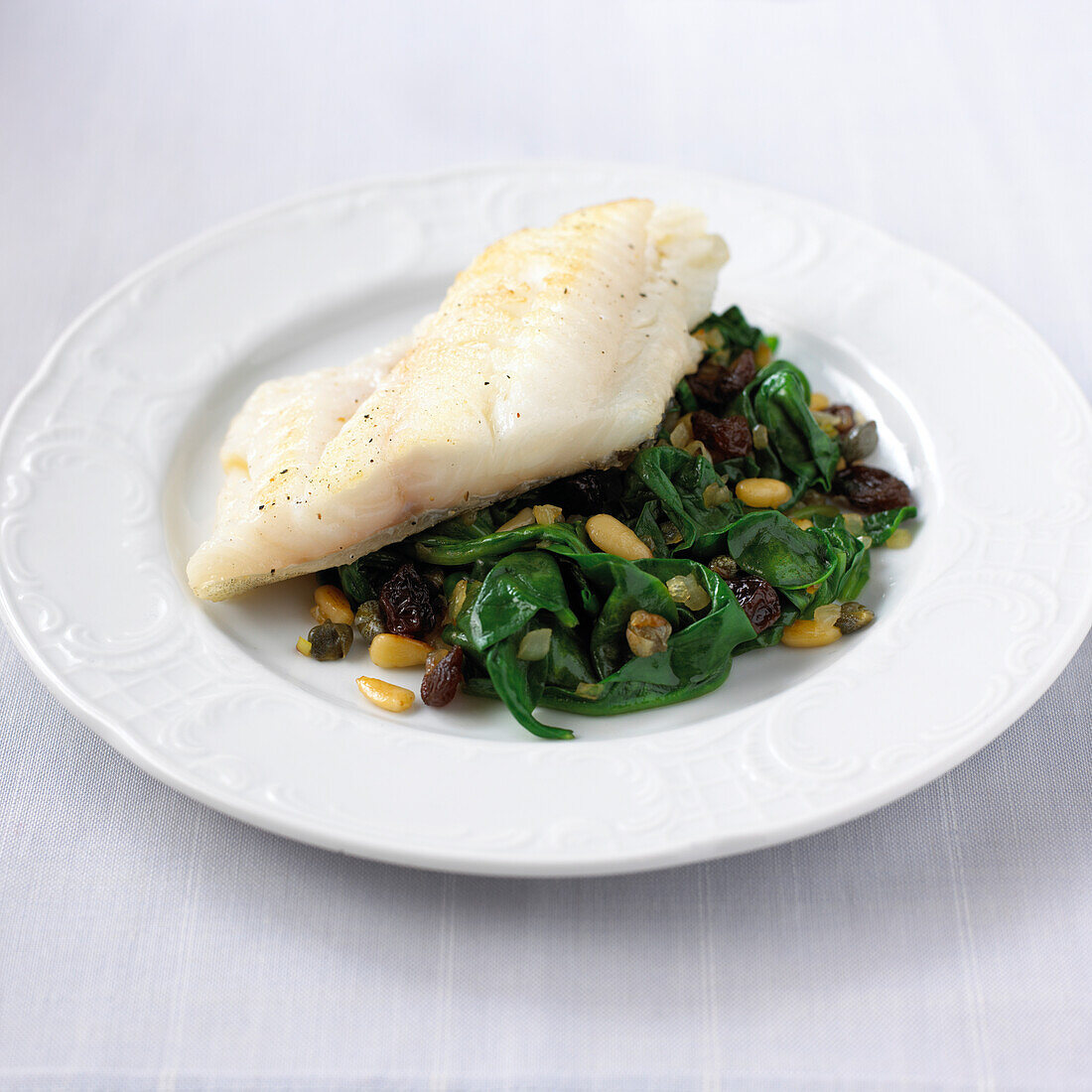 White fish with spinach and pine nuts