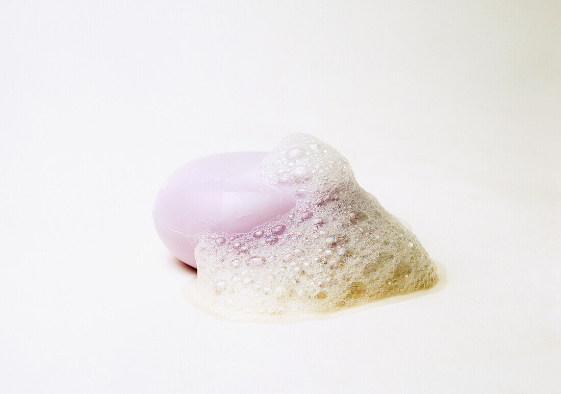 Purple soap bar covered in suds