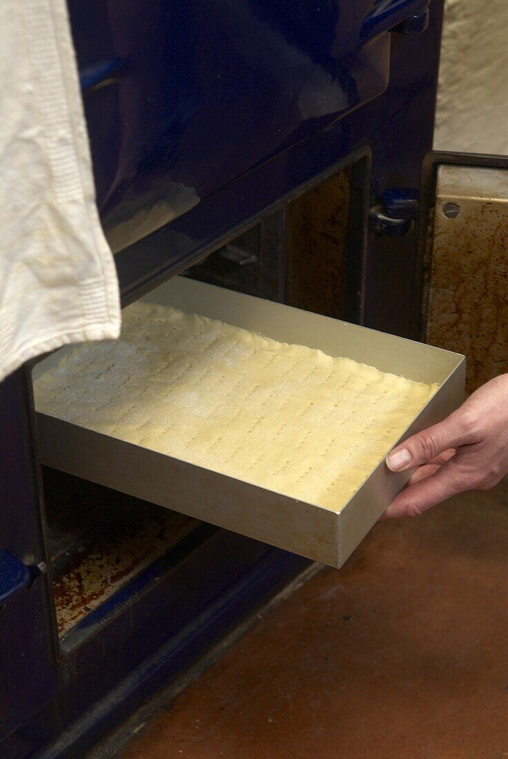 Placing shortbread into an oven