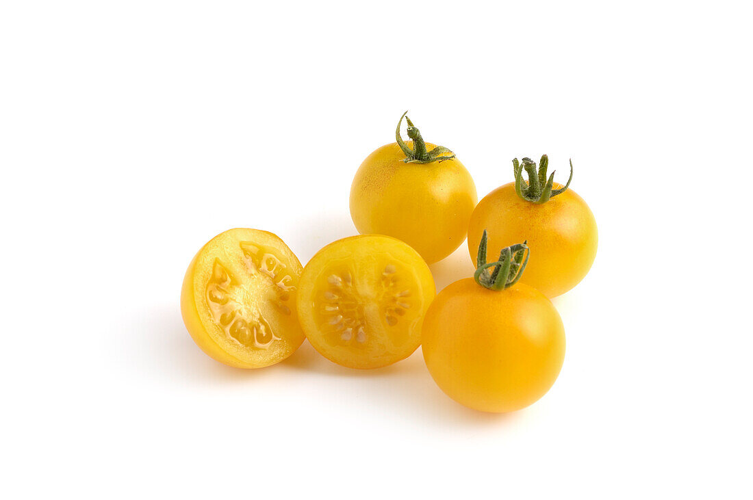 Whole and sliced Tumbling Tom Yellow tomatoes