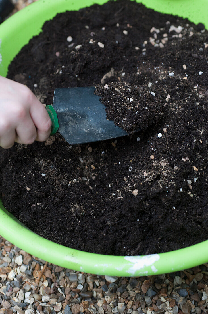 Mixing a bucket of compost and horticultural grit