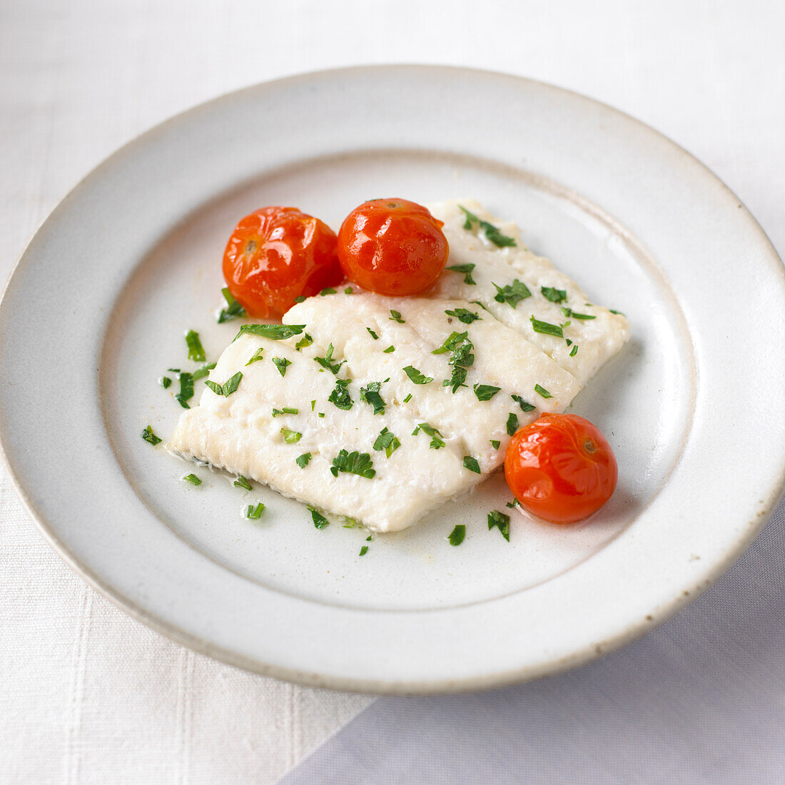 Baked white fish in wine and herbs, cherry tomatoes